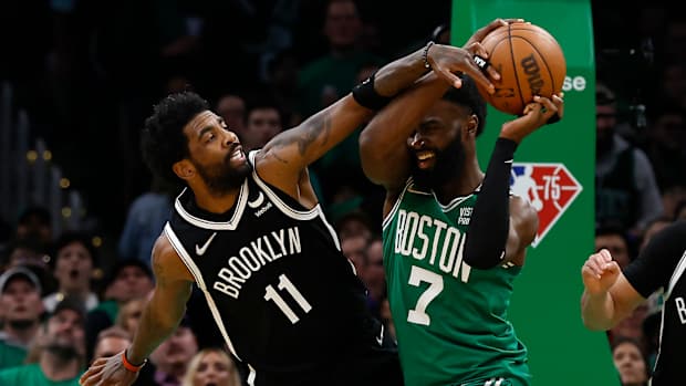 Kyrie Irving wears Air Jordan 1 Low 'Travis Scott' sneakers and Jaylen Brown wears Yeezy 700.